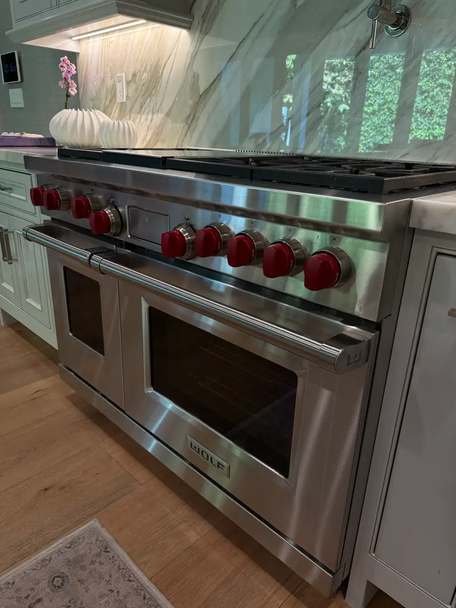 Wolf 48-inch dual-fuel range with signature red knobs in a South Bay kitchen