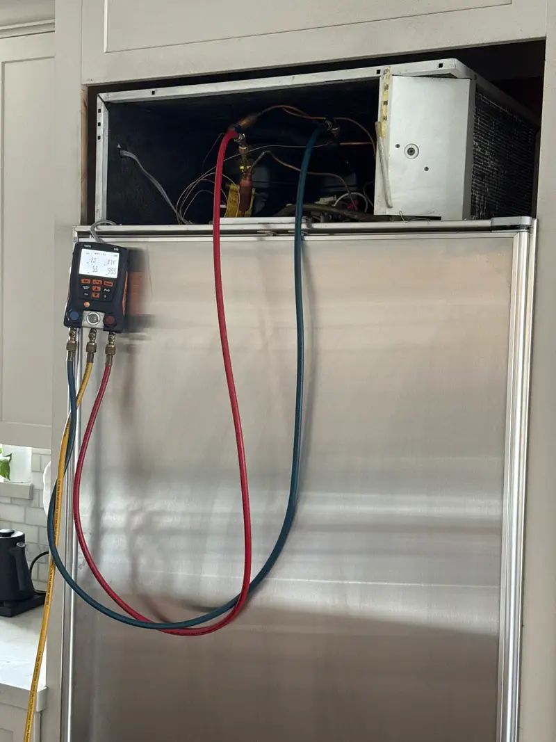 Digital manifold gauges connected to a Sub-Zero built-in refrigerator during refrigerant charging and pressure testing in Redondo Beach