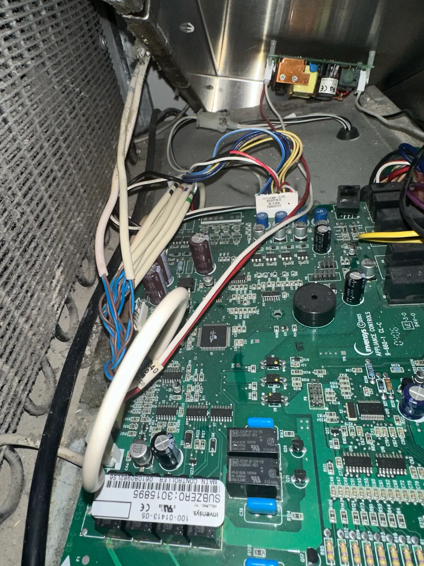 Close-up of a Sub-Zero main control board removed during a replacement
