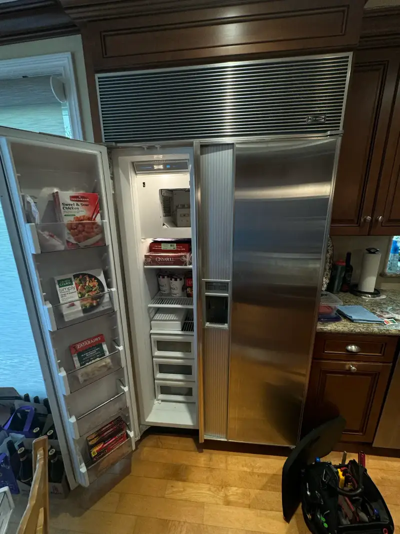 Sub-Zero built-in refrigerator with the freezer door open during a sealed-system repair
