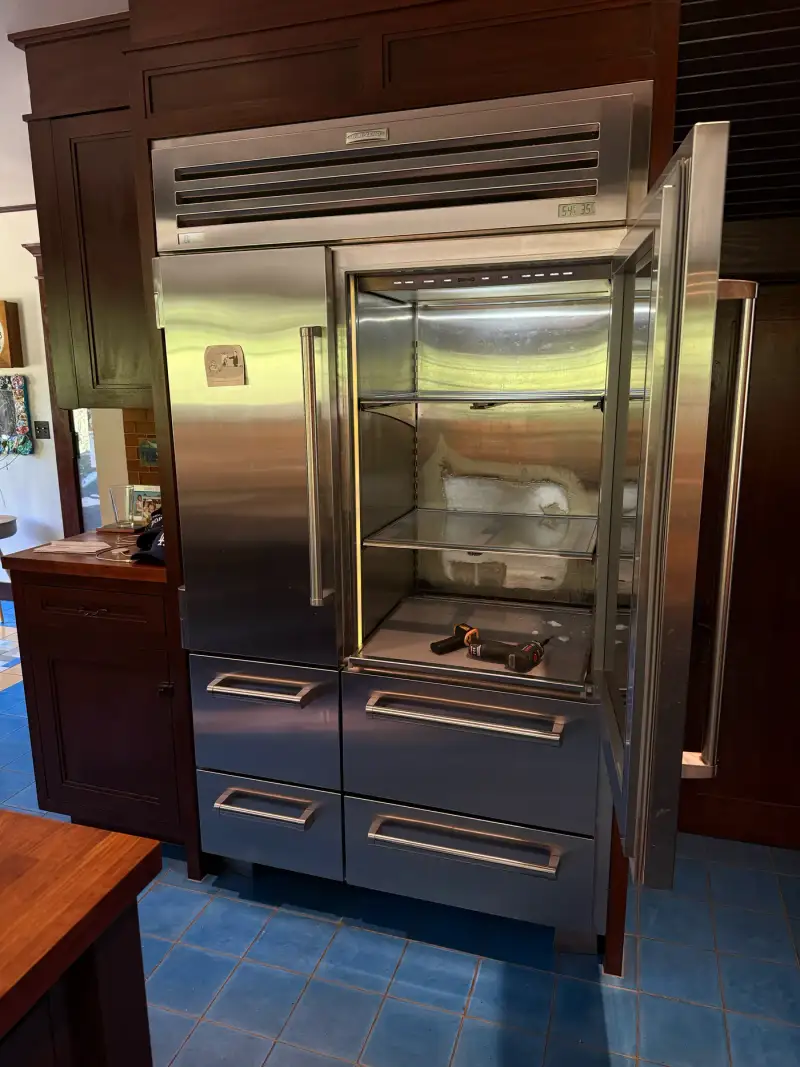Sub-Zero PRO 48 built-in refrigerator with the glass door open during a temperature sensor replacement