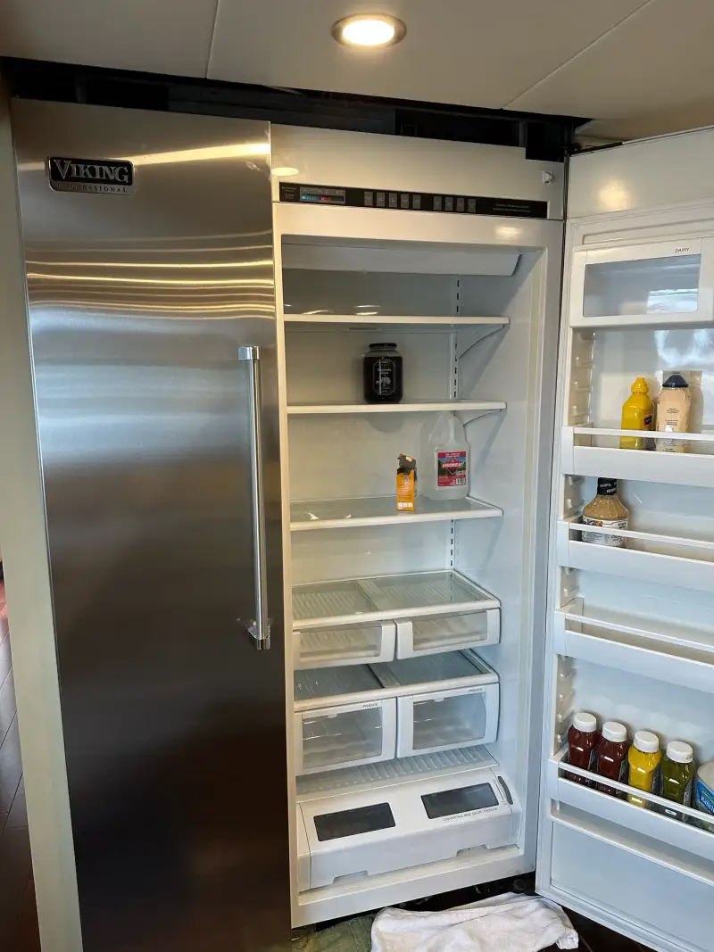Viking Professional built-in refrigerator emptied with door open during a service visit