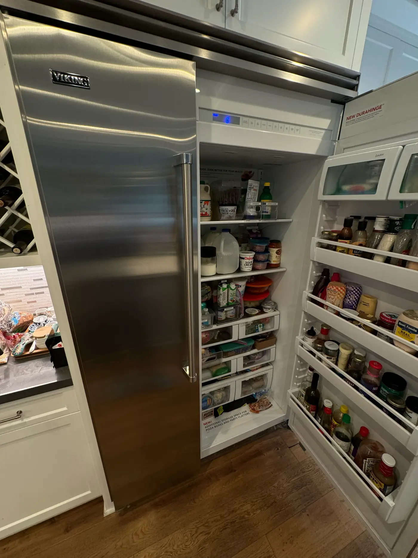 Viking built-in refrigerator column with the door open during a control-board service visit