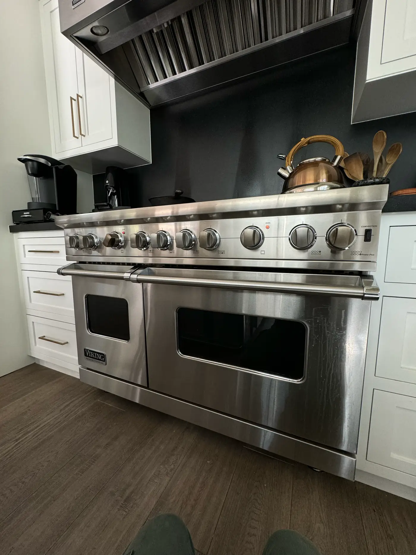 Viking Professional 48-inch double-oven range under a stainless hood in a modern white kitchen