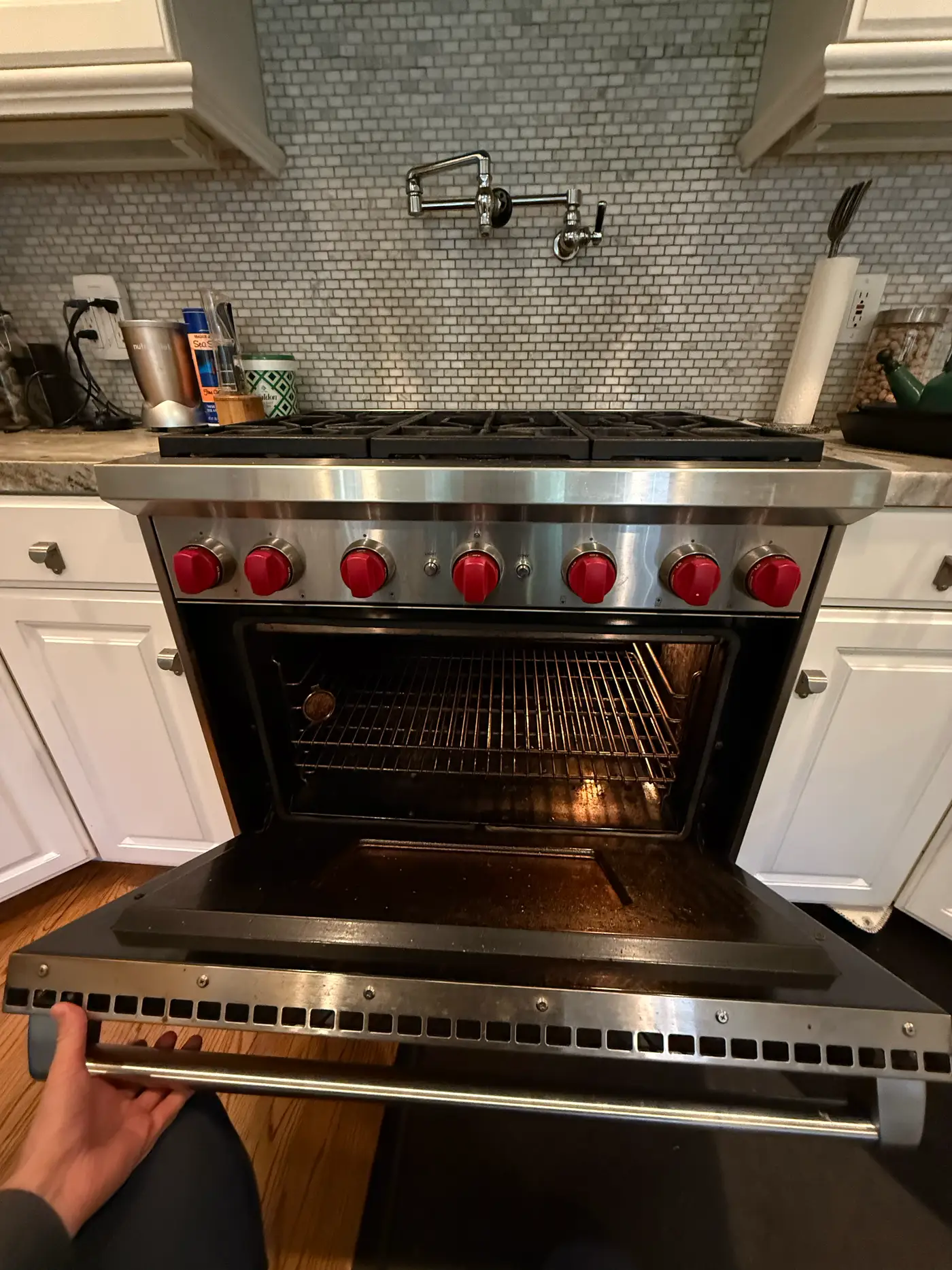 Wolf gas range with the oven door open and racks visible during an igniter service visit