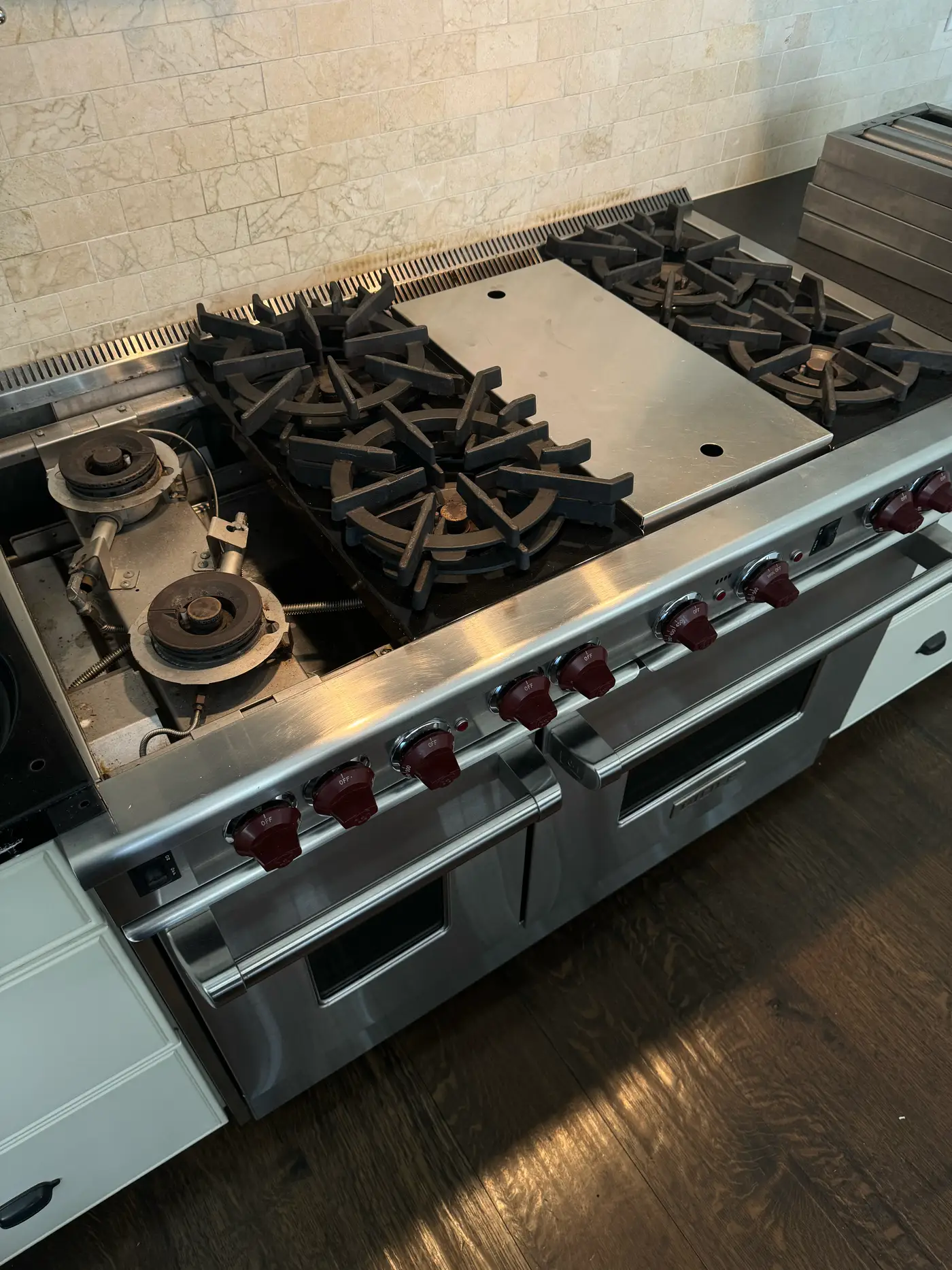 Wolf rangetop with grates removed and burners disassembled during a service visit